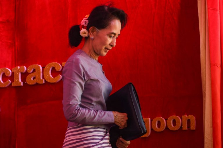 Daw Aung San Suu Kyi leaves the stage after addressing a press conference from her residential compund in Yangon on November 5, 2015. (AFP)