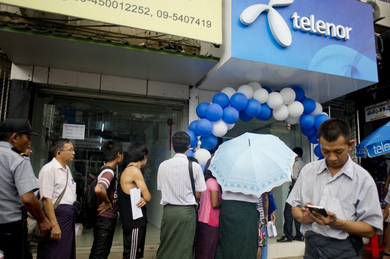 People line up to buy Telenor SIM cards in Yangon in October 2014, just after the company launched in Myanmar (AFP)