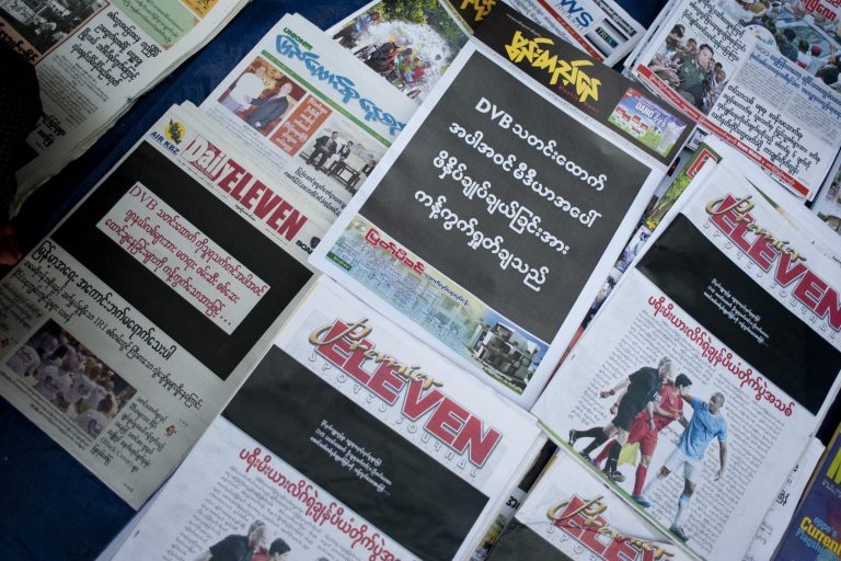 Newspapers including the Democratic Voice of Burma display black front pages at a Yangon news stall on April 11, 2014, after a DVB reporter was convicted of "disturbing a civil servant" for trying to get an interview with an education official. (AFP)