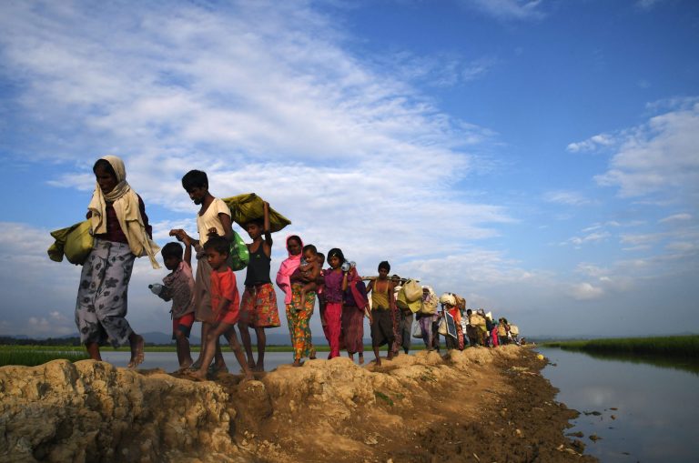 Rohingya refugees walk towards the Balukhali refugee camp in Bangladesh in November 2017, after fleeing from Myanmar. (AFP)