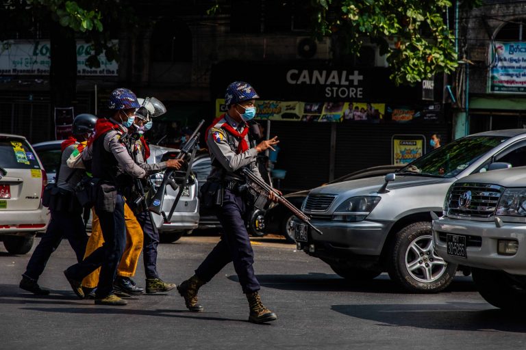 Armed police arrest a protester at an anti-coup demonstration in Yangon's Sanchaung Township on February 27. (Frontier)