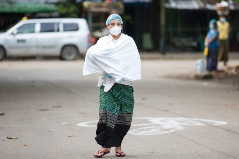 A woman carrying a baby walks towards a polling station in Botahtaung Township to cast her vote on November 8. This photo went viral on election day – but without a credit for the photographer. (Thuya Zaw | Frontier)