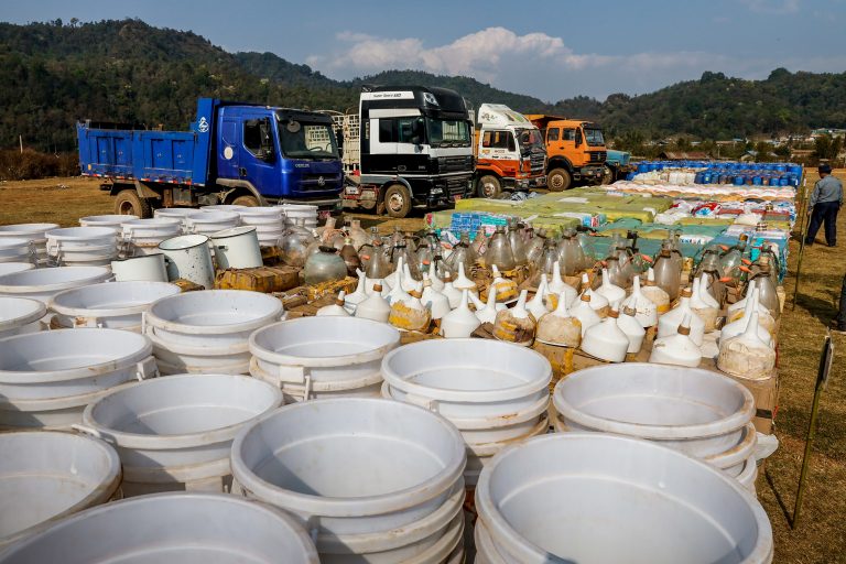 Drugs including crystal methamphetamine, yaba and heroin seized in raids in the Kawng Hkar area of northern Shan State are put on display together with vehicles, laboratory equipment and precursor chemicals at a government-organised event in Loi Kham village on March 6, 2020. (Hkun Lat | Frontier)