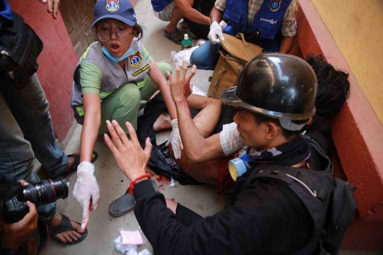 A volunteer medical worker frantically tries to save a person shot by security forces in Mandalay's Maha Aung Myay Township this afternoon. (Frontier)