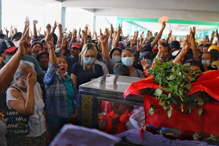 Mourners chant and give a three-finger salute at the funerals for three men killed in Yangon's North Okkalapa Township on March 3. (Frontier)