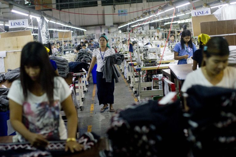 Women work at a garment factory in Yangon’s Shwepyithar Township on September 18, 2015. (AFP)