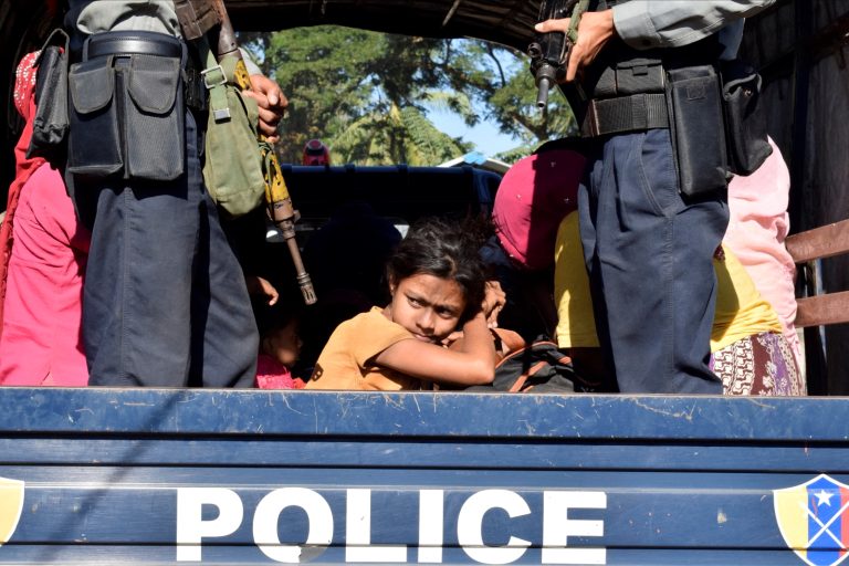 The police escort a group of Rohingya to one of the camps where tens of thousands have been confined since 2012 near the Rakhine State capital of Sittwe on November 30, 2018. (AFP)