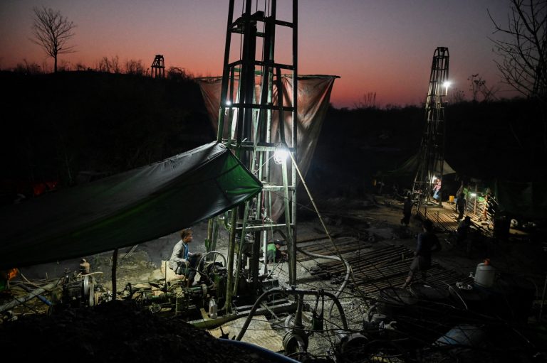 Workers operate machines to extract petroleum from a well at an informal oil field in Magway Region’s Minhla Township on March 10, 2019. (AFP)