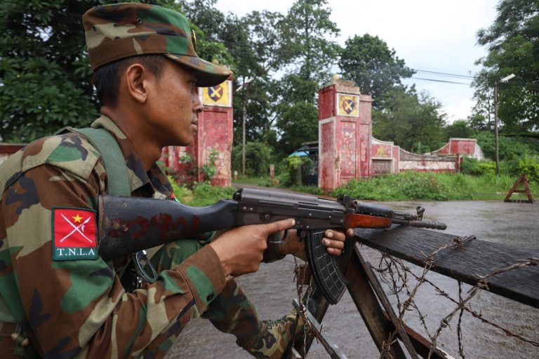 A member of the Ta'ang National Liberation Army keeps watch at a checkpoint in northern Shan State’s Kyaukme town on July 3. (AFP)