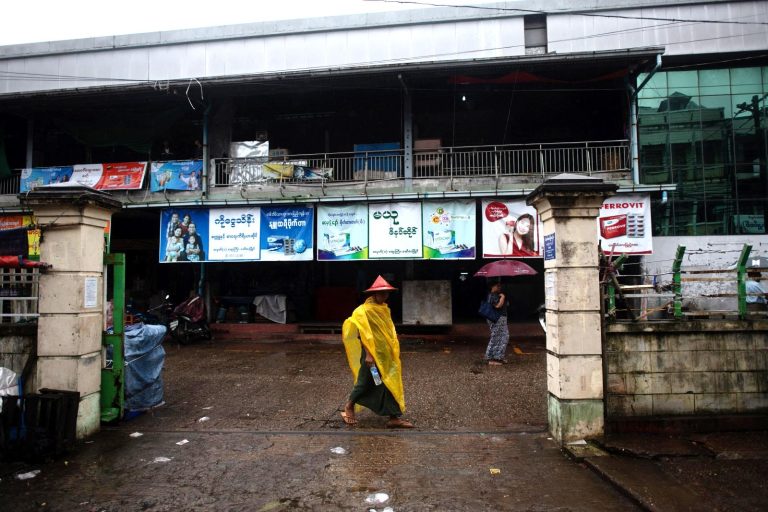 A man walks past the entrance to a market in  the Mon State capital Mawlamyine on July 16. (AFP)
