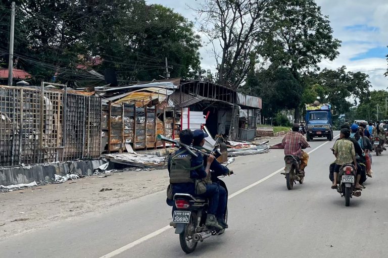 Members of the police force of the Myanmar National Democratic Alliance Army ride on a motorcycle in northern Shan State’s Lashio town on August 10. (AFP)