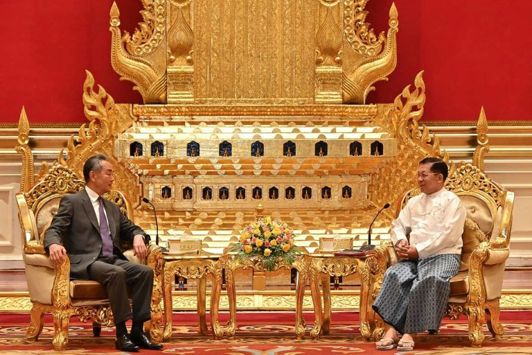 Junta chief Senior General Min Aung Hlaing meets with China's foreign minister Wang Yi yesterday in Nay Pyi Taw. (Myanmar Military Information Team | AFP)