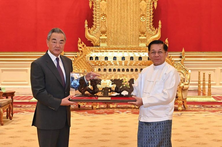 Senior General Min Aung Hlaing meets with China's foreign minister Wang Yi in Nay Pyi Taw on August 14. (Myanmar Military Information Team | AFP)