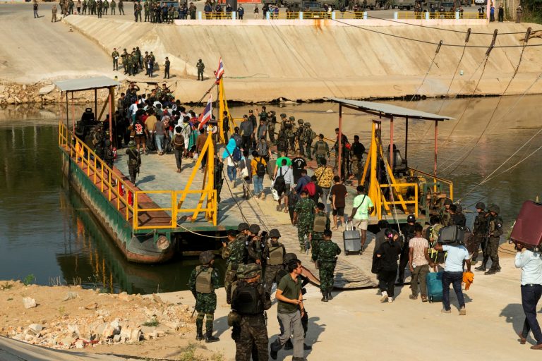 Alleged victims of cyber scam centres board a boat to cross the Moei River from Kayin State’s Myawaddy Township to Thailand, where they were met by Thai Army soldiers on February 12. (AFP)