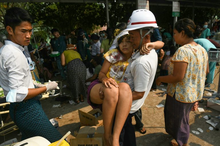 An earthquake survivor is carried as she waits to receive medical attention at a hospital in Nay Pyi Taw on March 28, after an earthquake in central Myanmar. (AFP)