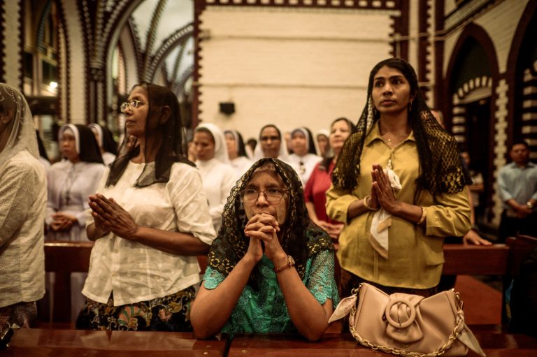 Catholics pray in memory of the late Pope Francis at St Mary’s Cathedral in Yangon on April 22. (AFP)