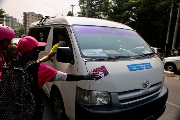 Foodpanda riders hand out flyers in February 2021, during the first mass protest after the coup. (Frontier)