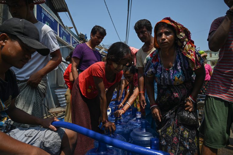 People queue for drinking water at a distribution point in Sittwe on May 17, 2023, in the aftermath of Cyclone Mocha's landfall. (AFP)