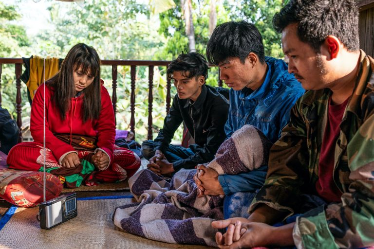 Villagers in eastern Bago Region listen to news of the February 1 coup over a radio, after the junta seized power and cut internet access across the country. (Frontier)