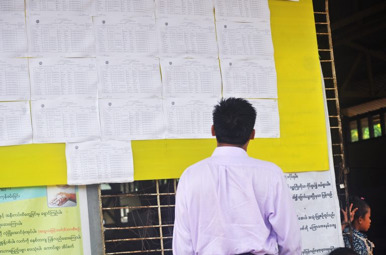 A man checks voter lists displayed in Zay Ward in Rakhine State's Ann Township.