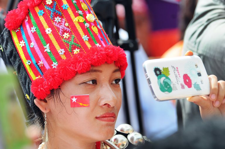 A Kachin woman attends a National League for Democracy rally in the Kachin State capital Myitkyina on October 2, 2015 ahead of the general election that year. (Steve Tickner | Frontier)