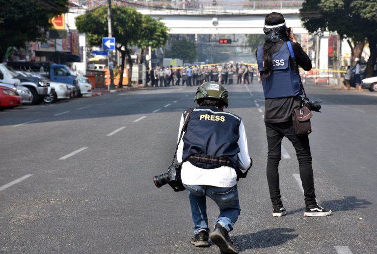 Photojournalists document a line of police and soldiers at a pro-democracy protest on Anawratha Road in downtown Yangon on February 28. (Frontier)