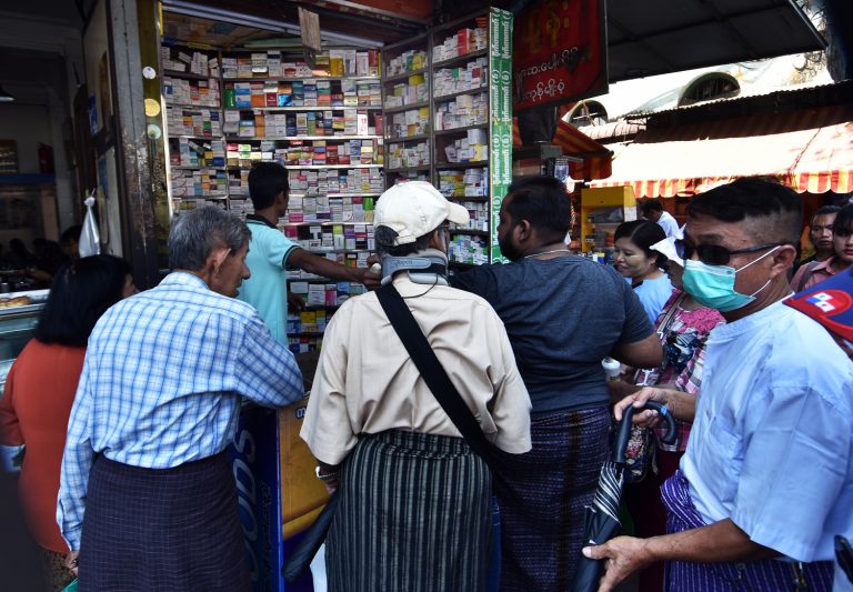 Residents gather at a pharmacy in downtown Yangon in response to the country's first confirmed COVID-19 cases in March 2020. (Frontier)