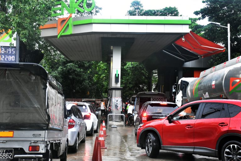 Long lines at a Denko fuel station pictured in Yangon in June extended hundreds of meters down the road. (Frontier)