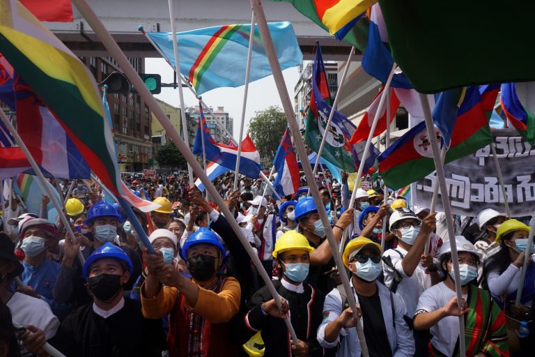 The mass street protests of February featured regular displays of inter-ethnic solidarity, but making space for more marginalised groups like the Rohingya will require a greater political transformation. Here, the flags of various ethnic groups are help up at an anti-coup demonstration in Yangon on February 18. (AFP)