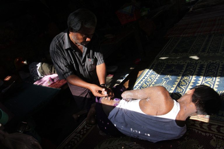 An HIV patient is treated by a volunteer doctor in Yangon on February 24, 2012. (AFP)