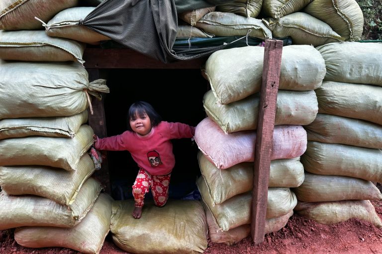 A girl emerges from a bomb shelter near her home amid clashes between the Ta'ang National Liberation Army and the military in northern Shan State’s Namhsan Township on December 14. (AFP)