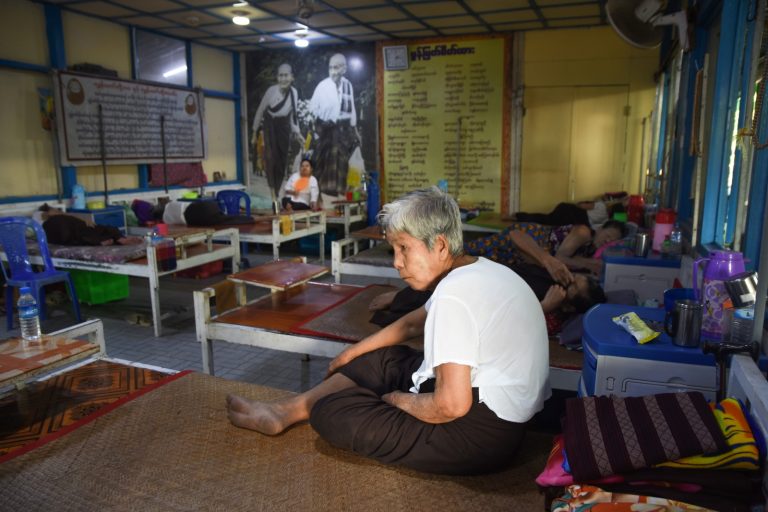 An elderly woman rests on her bed in the Monmyat Seikhtar Home for the Aged, in Yangon’s North Okkalapa Township, on January 5. (Lu Po | Frontier)