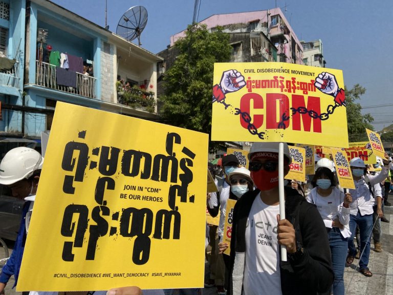 Protesters in Yangon hold placards in support of the Civil Disobedience Movement on February 24. (Frontier)