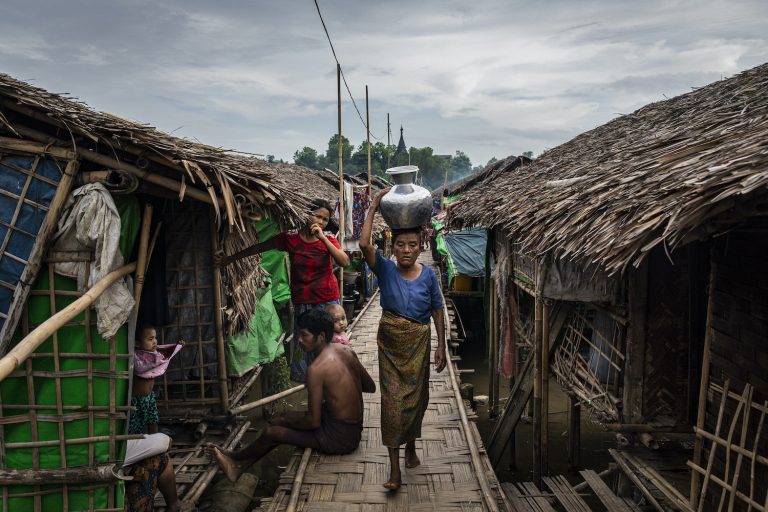 A woman walks through the Myadazaung IDP camp in Mrauk-U Township in 2020. (Frontier)