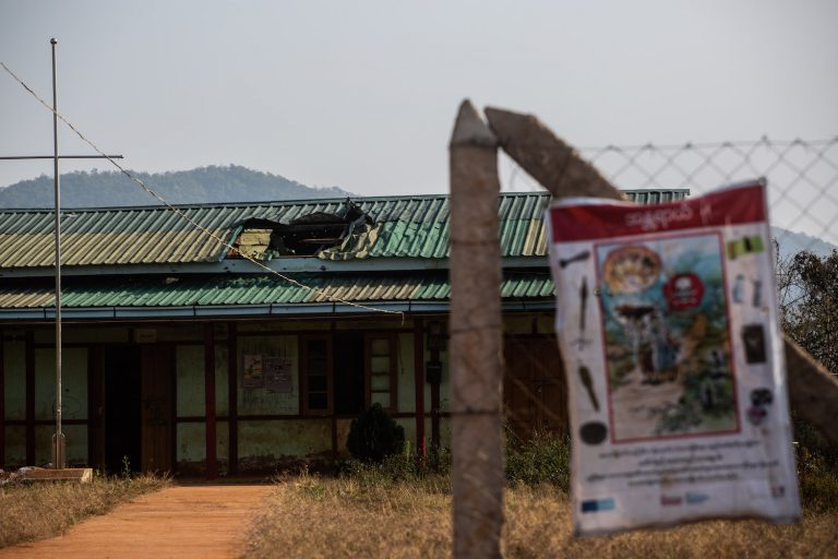 A notice warning of unexploded ordnances, posted in front of a school damaged by heavy artillery fire in Namtu Township, pictured in January 2022. (Mar Naw | Frontier)