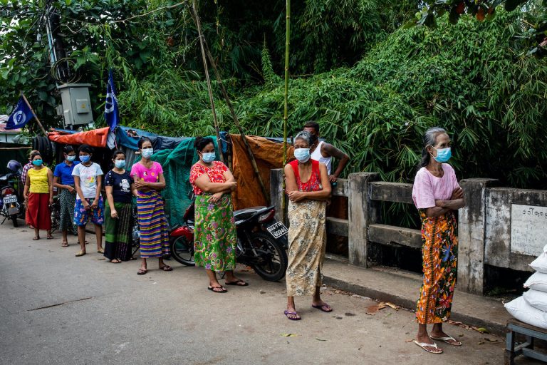 Mayangone Township residents keep their distance while lined up for donations of rice, fish and oil from political party campaigners on October 7. (Hkun Lat | Frontier)