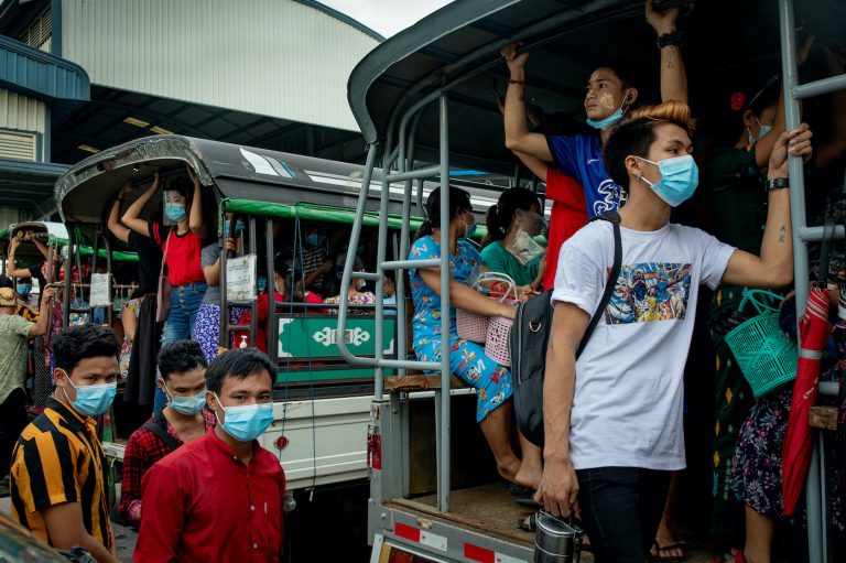 Factory workers pile into lorries headed back to workers' dorms in Hlaing Tharyar Township's Shwe Lin Ban Industrial Zone on October 28, 2020. (Frontier)