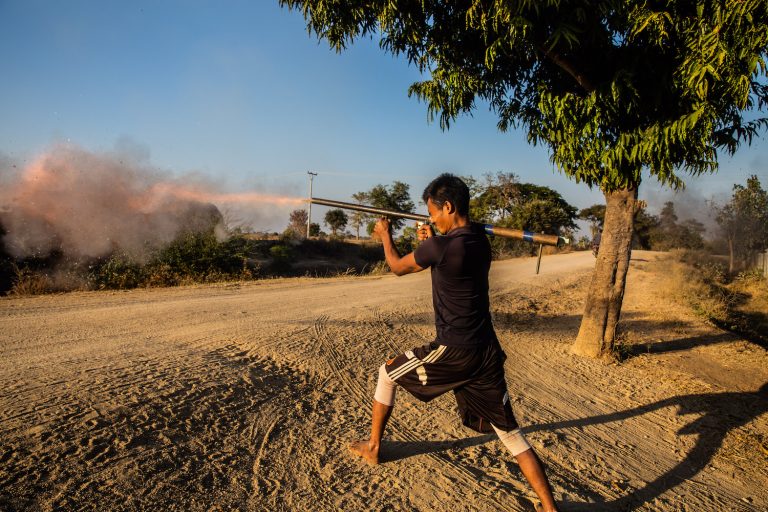 A PDF fighter tests a newly made weapon in Tabayin Township in February of this year. (Mar Naw | Frontier)