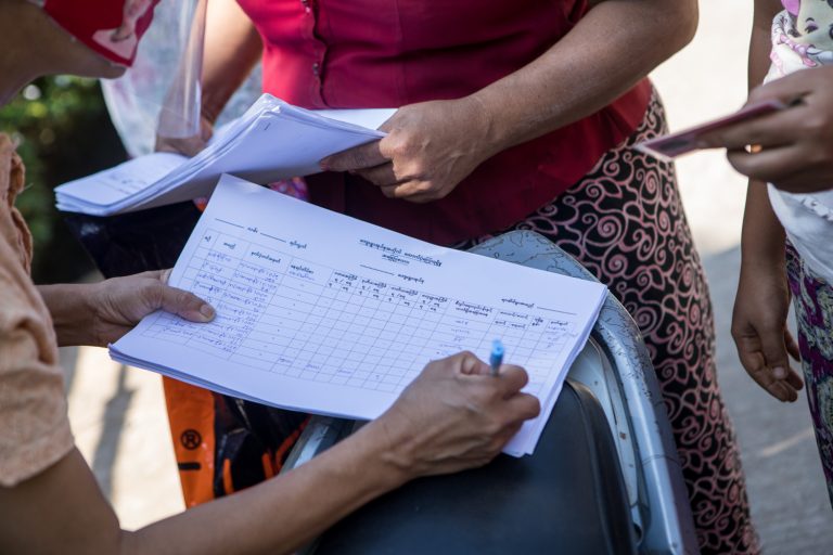 NLD staff survey residents of Yangon Region's Hmawbi Township on November 26, after complaints arose over which households did or did not receive payouts under the government's COVID-19 cash relief programme. (Thuya Zaw | Frontier)