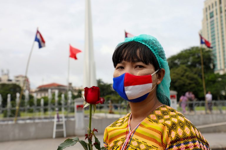 A woman wearing a face-mask with the colours of the Karen national flag at a Karen Martyrs' Day ceremony in Yangon on August 12 this year. (Thuya Zaw | Frontier)