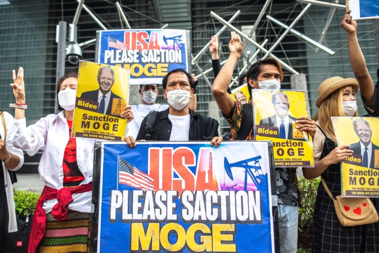 Myanmar activists in Tokyo demonstrate with placards calling on the United States to sanction the Myanma Oil and Gas Enterprise ahead of US President Joe Biden's visit to the city in May last year. (AFP)