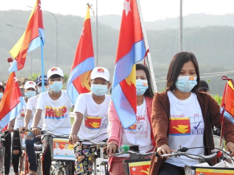 Mon Unity Party supporters cycle down a street in Chaungzon Township, on Mon State's Bilu Island, near the state capital, Mawlamyine on November 4. (Supplied/Nai Mon)