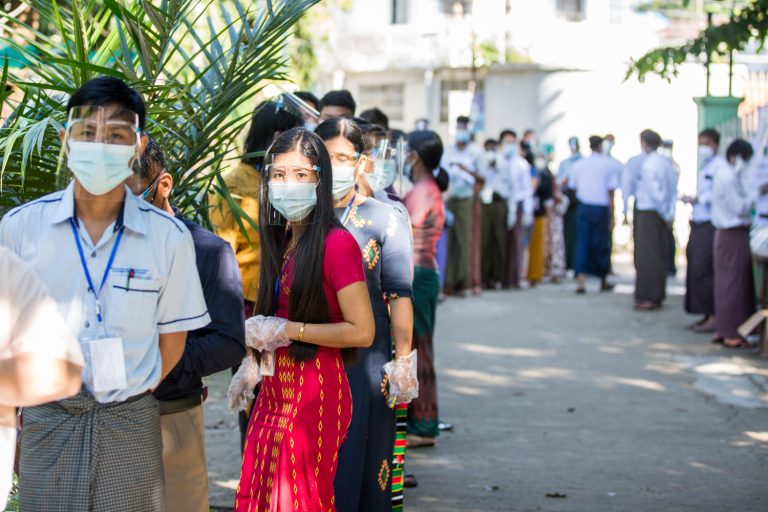 Voters in COVID-19 protective gear queue up to vote at a Mayangone Township polling station on November 9. (Thuya Zaw | Frontier)