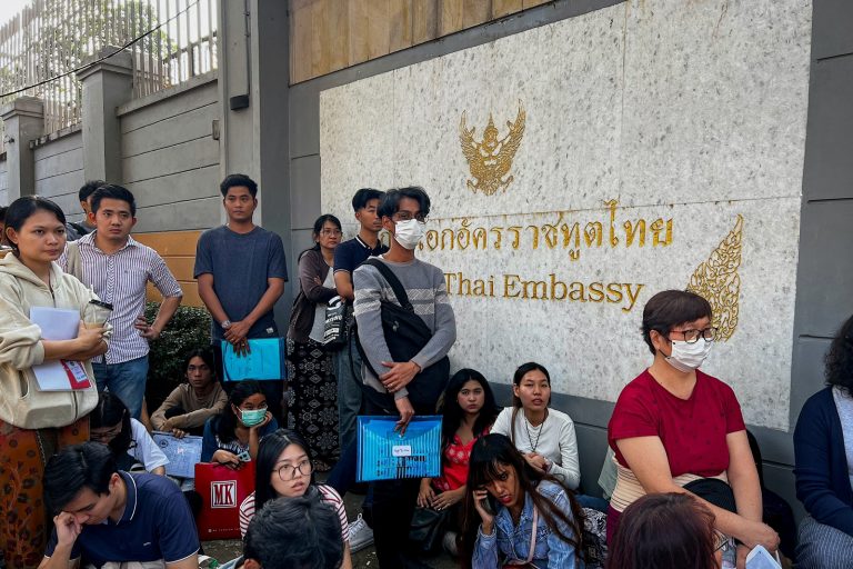 People gather outside the embassy of Thailand in Yangon to apply for visas on February 16, days after the junta announced it would impose military service. (AFP)