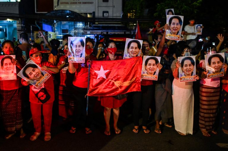 Supporters of the National League for Democracy hold portraits of party leader Daw Aung San Suu Kyi as they celebrate the NLD’s 2020 election victory outside its headquarters in Yangon on November 9 last year, a day after the vote. (AFP)