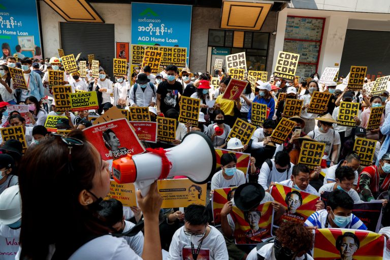 Protesters hold signs supporting the Civil Disobedience Movement (Frontier)