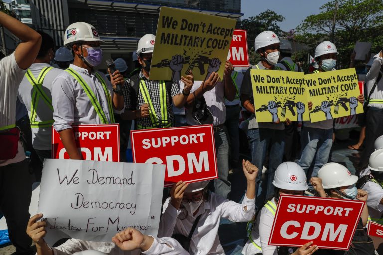 Protesters in Yangon hold placards urging the public to support the Civil Disobedience Movement on February 25. (Frontier)