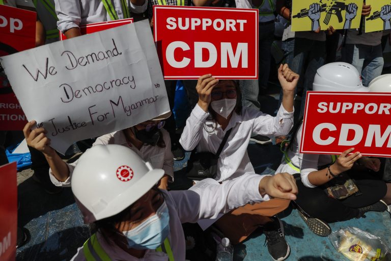 Protesters in Yangon hold placards urging the public to support the Civil Disobedience Movement on February 25. (Frontier)