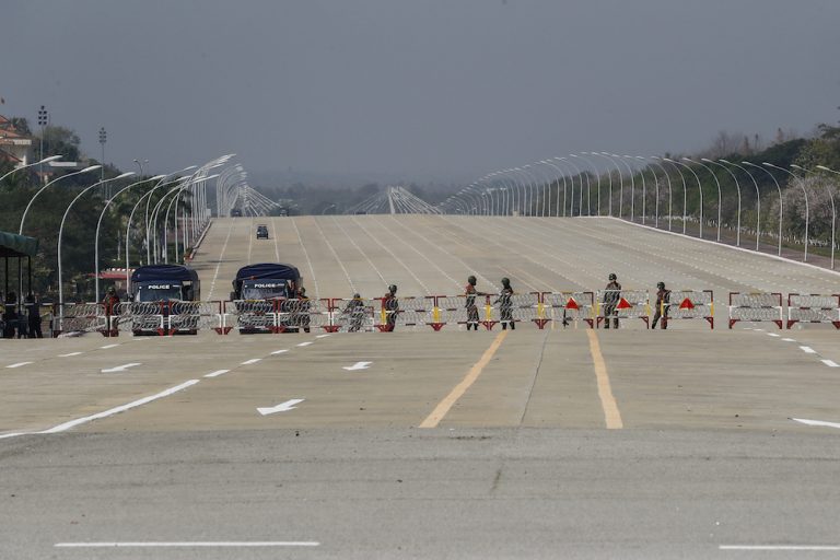 Police and Tatmadaw soldiers erect a barricade across a major road in Nay Pyi Taw on February 2. (Frontier)