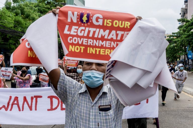 A protester carries a placard in support of the newly formed National Unity Government during a demonstration in Yangon's Thingangyun Township on April 30. (AFP)